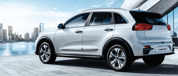 White Kia Niro EV SUV next to a building