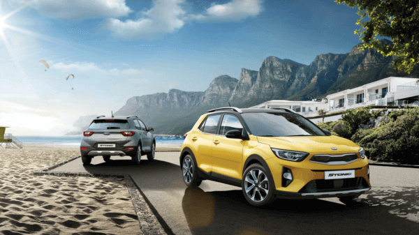 Yellow and Gray color Kia Stonic SUVs on a beach