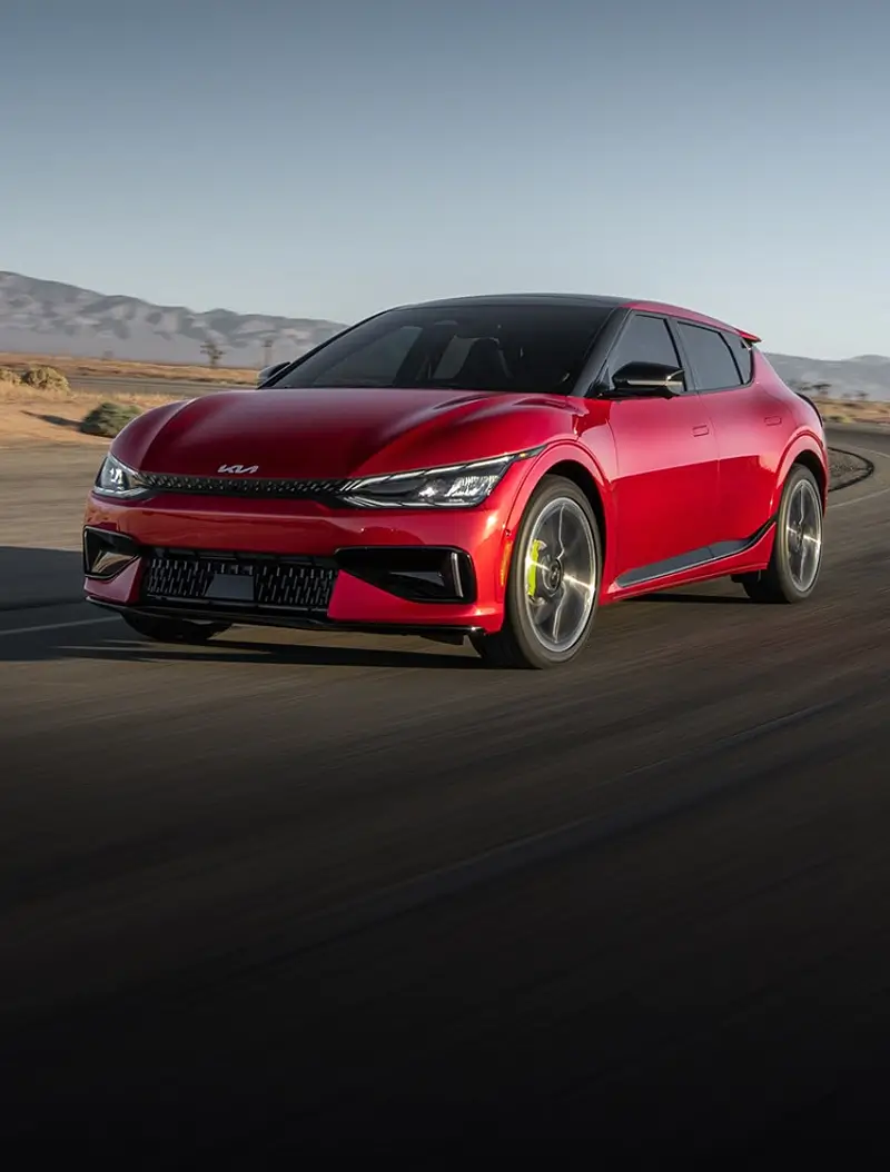 A red color Kia EV GT 6 Hatchback car driving in a road